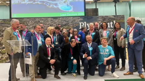 Reform UK councillors and party members celebrate on the stage at the Plymouth City Council local election count.