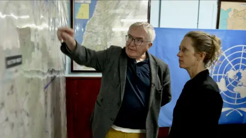 UNDOF Chief of Mission Bernard Lee (L) shows the BBC's Lucy Williamson a map at UNDOF's Camp Ziouani base, in the Israeli-occupied Golan Heights