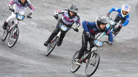 Briantree BMX Club Poppy in the lead, with other BMX riders behind her at the world championships