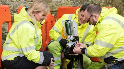 Wildanet Wildanet chief executive officer Helen Wylde-Archibald with two people working on an installation
