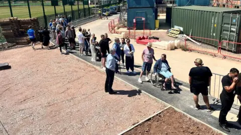 BBC The queue of people outside the show home