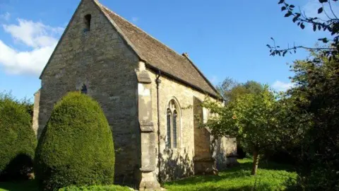 Bartlemas Chapel is a small stone chapel surrounded by greenery.