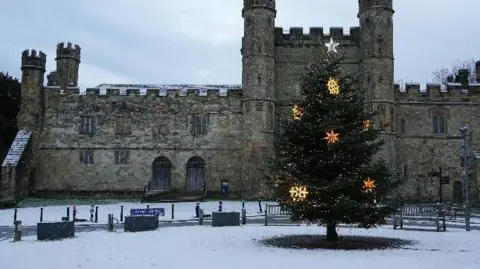 Peter and Leah/BBC Weather Watchers Exterior of Battle Abbey in the snow with a big Christmas tree