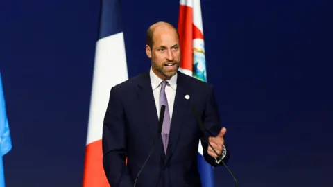 Reuters Prince William is speaking on stage.