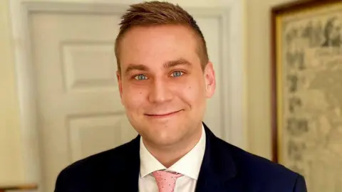 Labour Party Matthew Wright in a suit and pink tie 