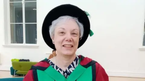 Carol Vaughan Carol Vaughan, informal portrait wearing a university graduation gown