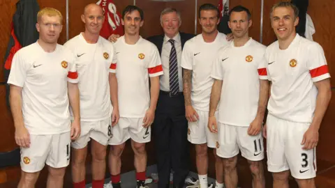 Getty Images Paul Scholes, Nicky Butt, Gary Neville, Sir Alex Ferguson, David Beckham, Ryan Giggs and Phil Neville of Manchester United pose in the dressing room ahead of Gary Neville's testimonial match between Manchester United and Juventus at Old Trafford in May 2011.