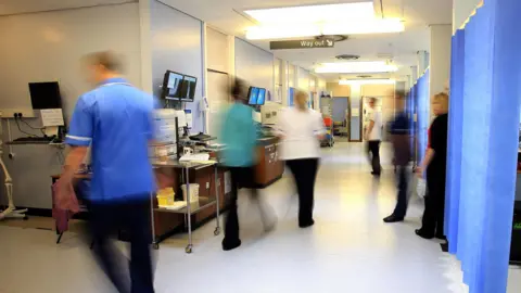 PA Media File photo of staff on a NHS hospital ward