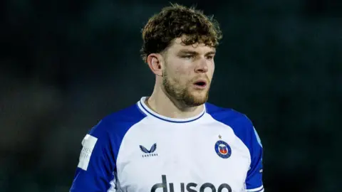 Ethan Staddon standing on the pitch during a match this season