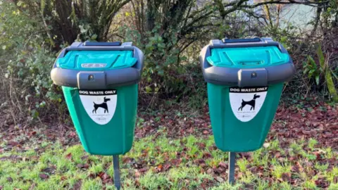 Two dog bins side by side