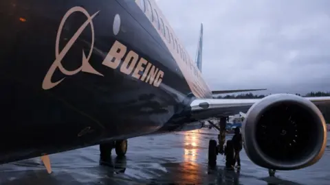A Boeing 737 Max aircraft is parking outside of an airplane hangar 