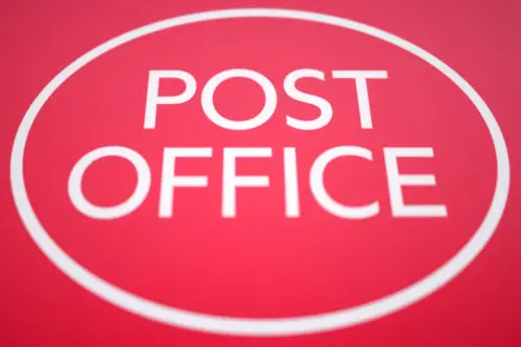 A big red Post Office sign, with a white circle round it