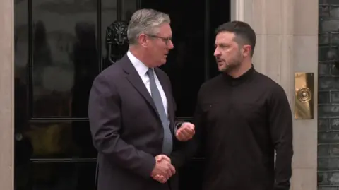 BBC Sir Keir Starmer and Ukrainian President Volodymyr Zelensky shake hands as he arrives at Downing Street