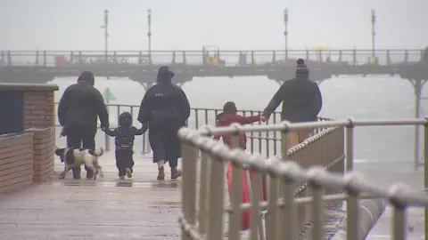 BBC A family on a rainy and windy pier
