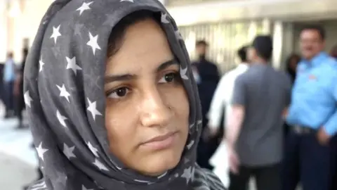 Woman wearing headscarf with stars outside Islamabad's PIMS hospital