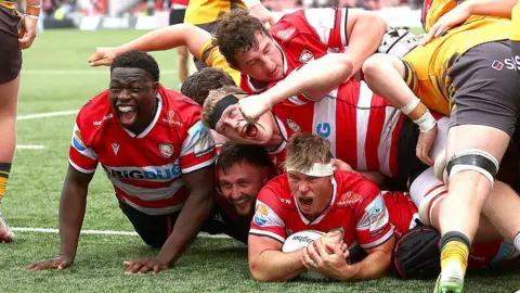 James Venter of Gloucester Rugby celebrates scoring a try, with his teammates, during the Gallagher PREM match between Gloucester Rugby and Newcastle Red Bulls at Kingsholm Stadium.