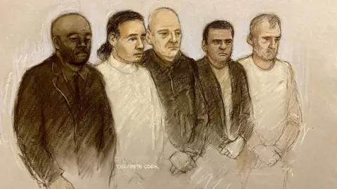 PA Media A court sketch of the five defendants. Left to right,  Norman Macksoni, Connor Sanderson Doyle, Richard Wilkins, Mohammed Hassan and Dean Hamilton. Mr Macksoni is wearing a dark suit jacket and a dark shirt and is bald. Mr Sanderson Doyle has dark hair tied back in a ponytail and wears a white rollneck jumper. Mr Wilkins is balding with grey hair and wears a dark jacket. Mr Hassan is wearing a grey T-shirt and dark jacket, and has black hair. Mr Hamilton is looking down and has grey hair, and wears a white top. 