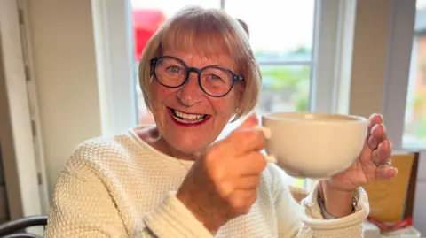 Stuart Woodward/BBC Ann Weymouth with coffee cup