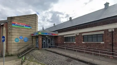 Pudsey Leisure Centre, a single-storey building with a wheelchair accessible ramp.
