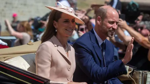 Anadolu via Getty Images Princess of Wales Catherine and Prince of Wales William wave to crowds as they sit in a carriage.
