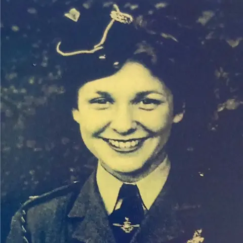 Blind Veterans UK Mary Cliff, smiling while wearing a Navy uniform in a black and white image