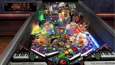 Farsight Pinball machine showing flippers at the front and monster characters on various obstacles in the playing area.  Part of a piano keyboard is visible at the front