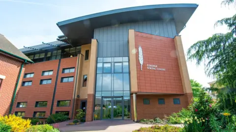 Moulton College A brick and glass school college building with two large double doors and overhanding roof 