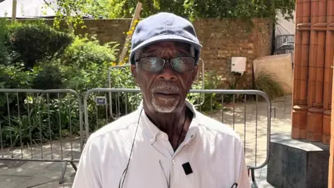 Sound system operator Gladdy Wax stands outside a building in west London after speaking about his decades of involvement in Notting Hill Carnival.
