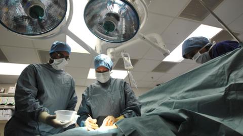 Surgeons in an operating theatre