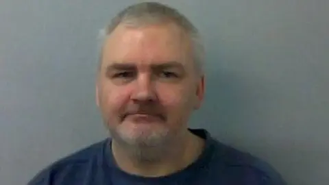 Thames Valley Police Guido Schuette has short, white hair and white stubble.