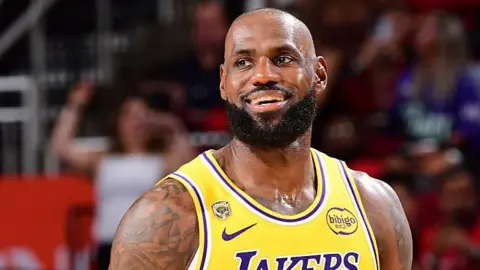 LeBron James smiles while playing for the Los Angeles Lakers against the Houston Rockets in game three of their 2026 NBA play-off series