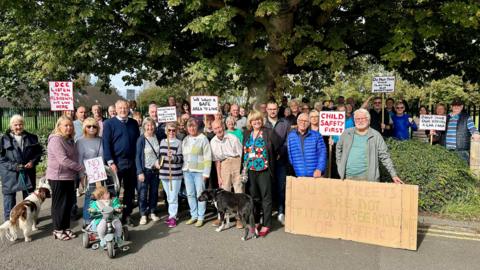 Campaigners with placards protest against the plans