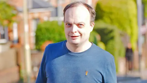 Philip Jerome arriving at Basingstoke Magistrates' Court, Hampshire, to be sentenced for breaching a restraining order. He is looking at the camera and seemingly smiling