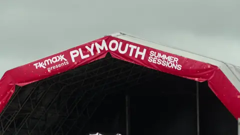 Banner on top of the Plymouth Summer Sessions stage. It says TK-Maxx presents Plymouth Summer Sessions.