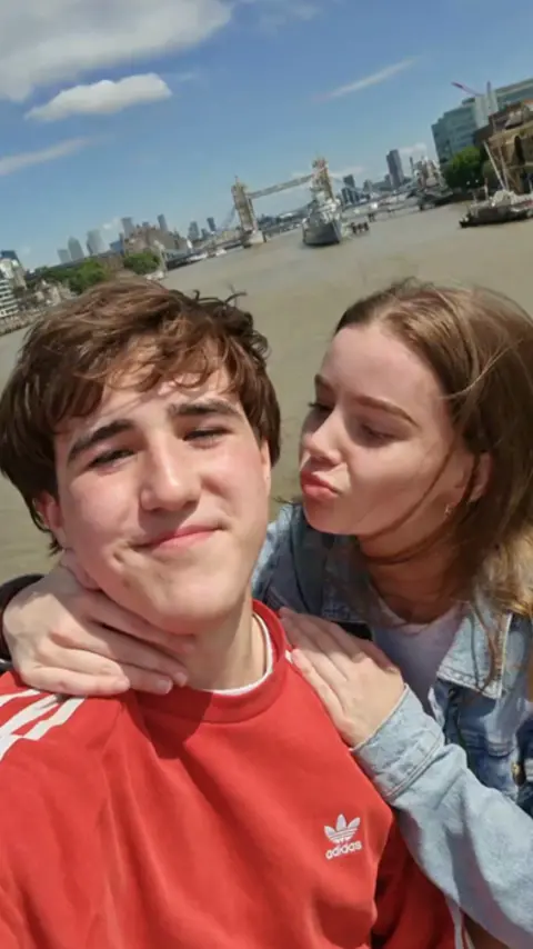 The Port of London Authority A teenage boy and girl stand with the River Thames behind them in the background, in a vertical video format.