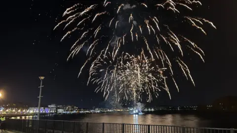 BBC Shows a fireworks display on a river