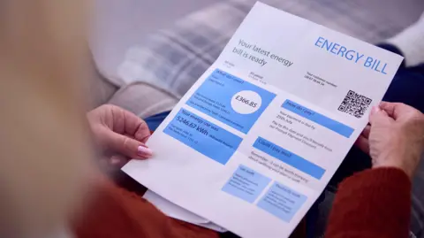 Getty Images Two hands holding a domestic energy bill for £336.85