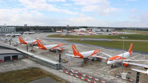 Richard Smith/PA Four planes parked in a row on a runway branded with the easyJet logo