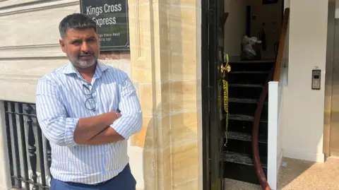 ANGIE GEORGE/BBC Sanjay Swaminarayan outside King's Cross Express Inn on Sunday afternoon