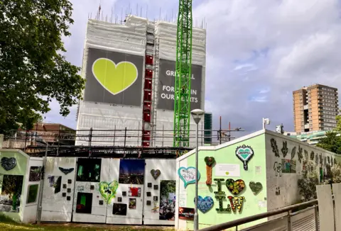 BBC memorial wall , green heart, tower block, with scaffolding 