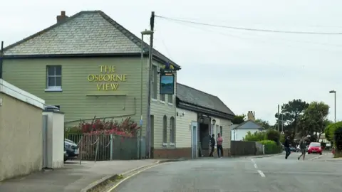 Robin Webster / Geograph An old photo of The Osborne View pub. A pale green two-storey building with a grey pitched roof and covered in weatherboard.