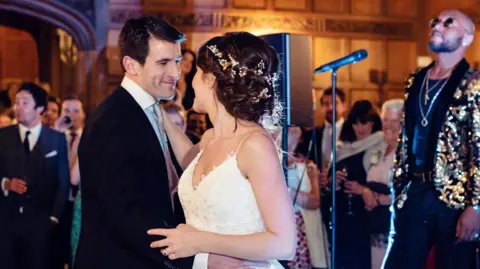 A bride and groom dancing together at their wedding.