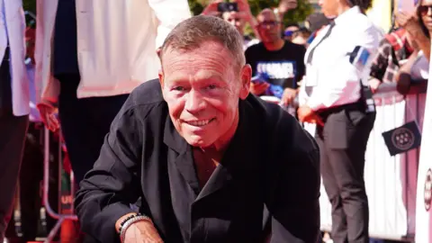 PA A picture of Ali Campbell smiling and wearing a black shirt