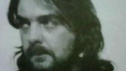 Andrew Barlow with long hair and beard