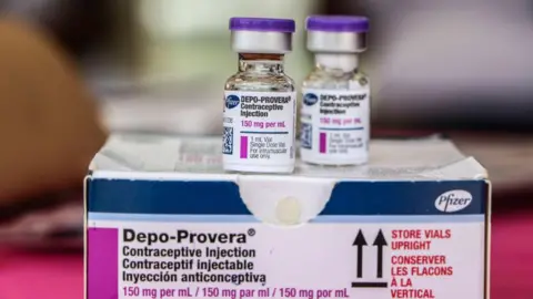 Getty Images Two small bottles Depo Provera sitting on top of a Pfizer box 