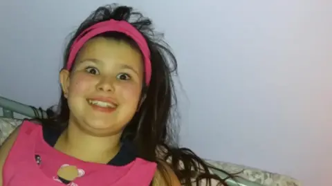 Jayne Reynolds A teenage girl smiling at a camera.