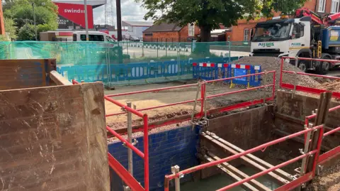 BBC Large hole being repaired in County Road by football stadium