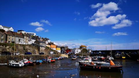 A small picturesque harbour under a bright blue sky