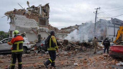 Rescuers work among the rubble following a Russian strike on a residential area in Kyiv