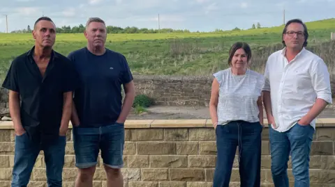 Four residents from Chapel Town - mentioned later in the story - are stood in front of a stretch of green belt land next to their street.